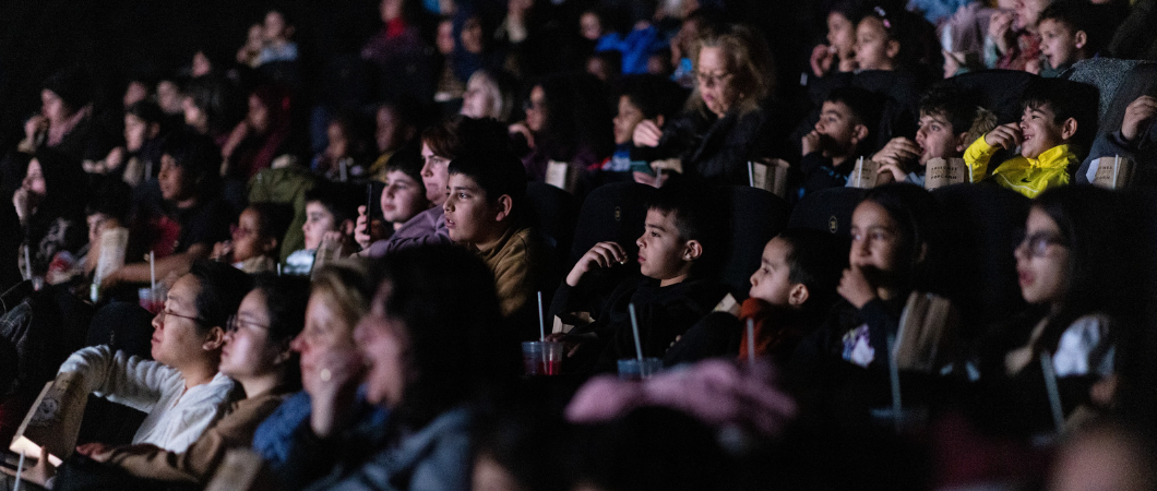 Children in the cinema are spellbound watching a film
